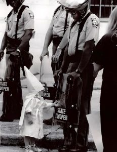 The Photograph Of A White Child And A Black State Trooper Captured In A KKK Protest, 1992