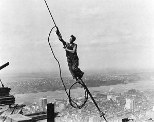 What Hidden Meanings Lie Behind Lewis Hine’s 1931 Masterpiece, “Icarus Atop Empire State Building”?