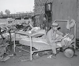 Behind The Photo Man With His Daughter Sitting On Bed Under Bridge, 1939